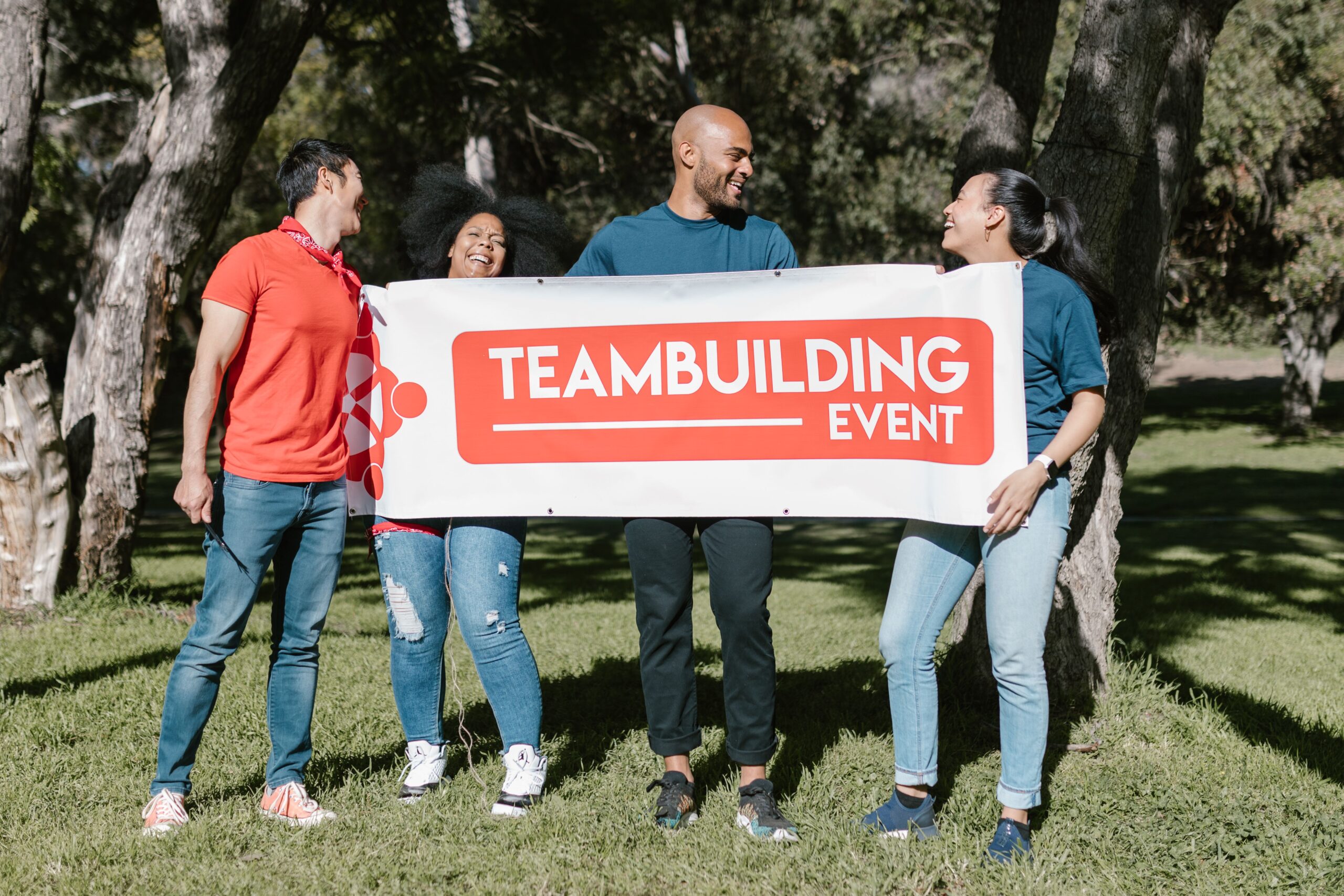 A group of colleagues enjoying a fun team building event in a park.